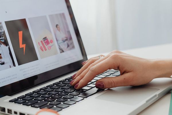 Person using laptop in a well-lit ergonomic workspace